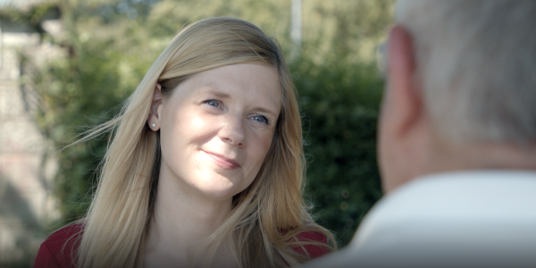 Claire Hazelgrove listening to a local resident in a park